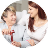 caregiver and senior woman looking at each other