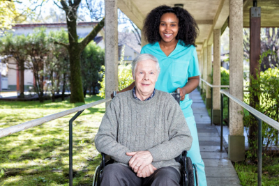 caregiver and senior woman outside senior home